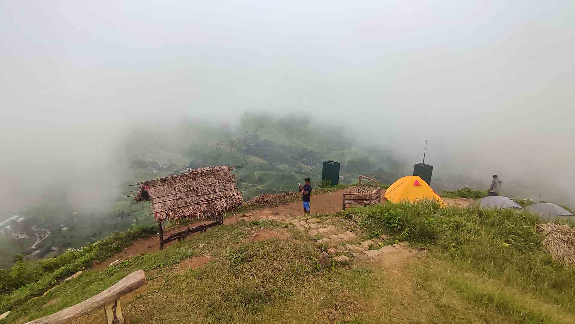 Kalabokka 360 Upper Division Viewpoint summit with misty valley views, thatched shelter and camping tents in the Knuckles region